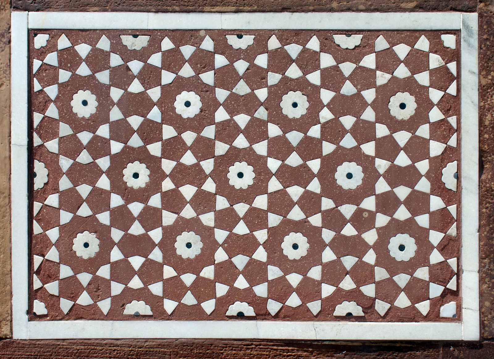 The red sandstone gateway of the Itimad-ud-Daulah garden in Agra inlaid with white marble patterns