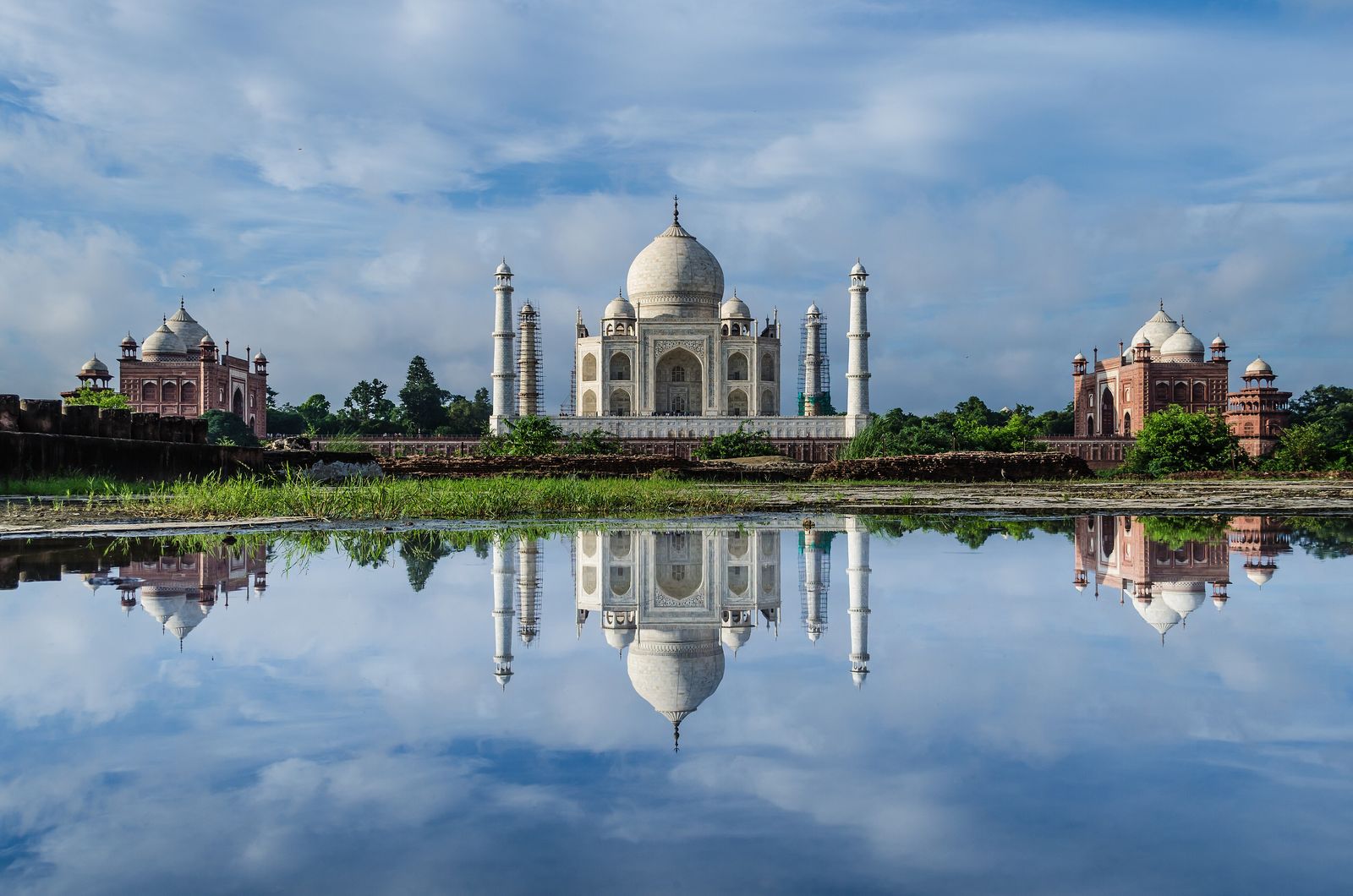 The Taj Mahal seen across the Yamuna river from the gardens of Mehtab Bagh in evening light