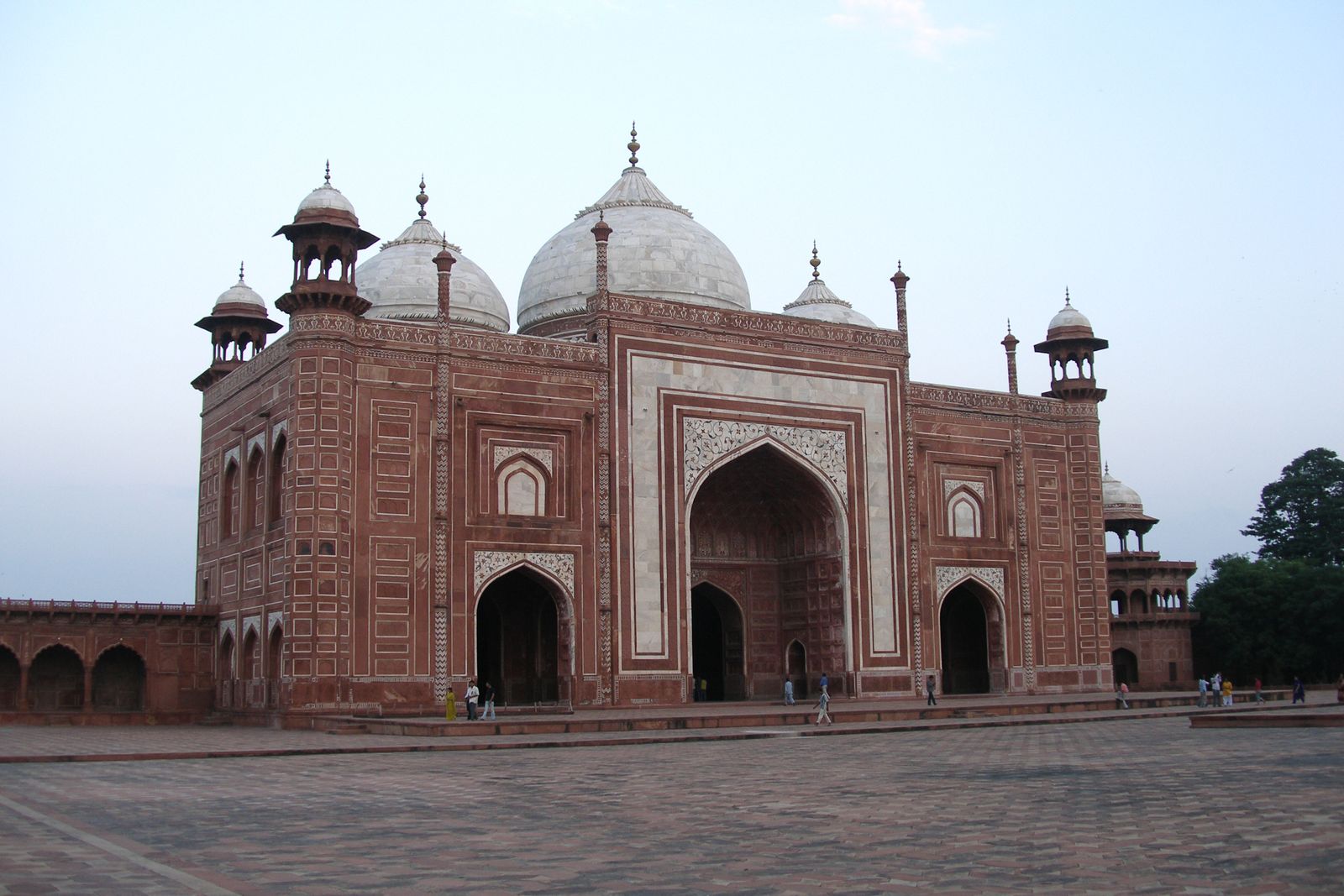The red sandstone mosque with three white marble domes on the western side of the Taj Mahal complex