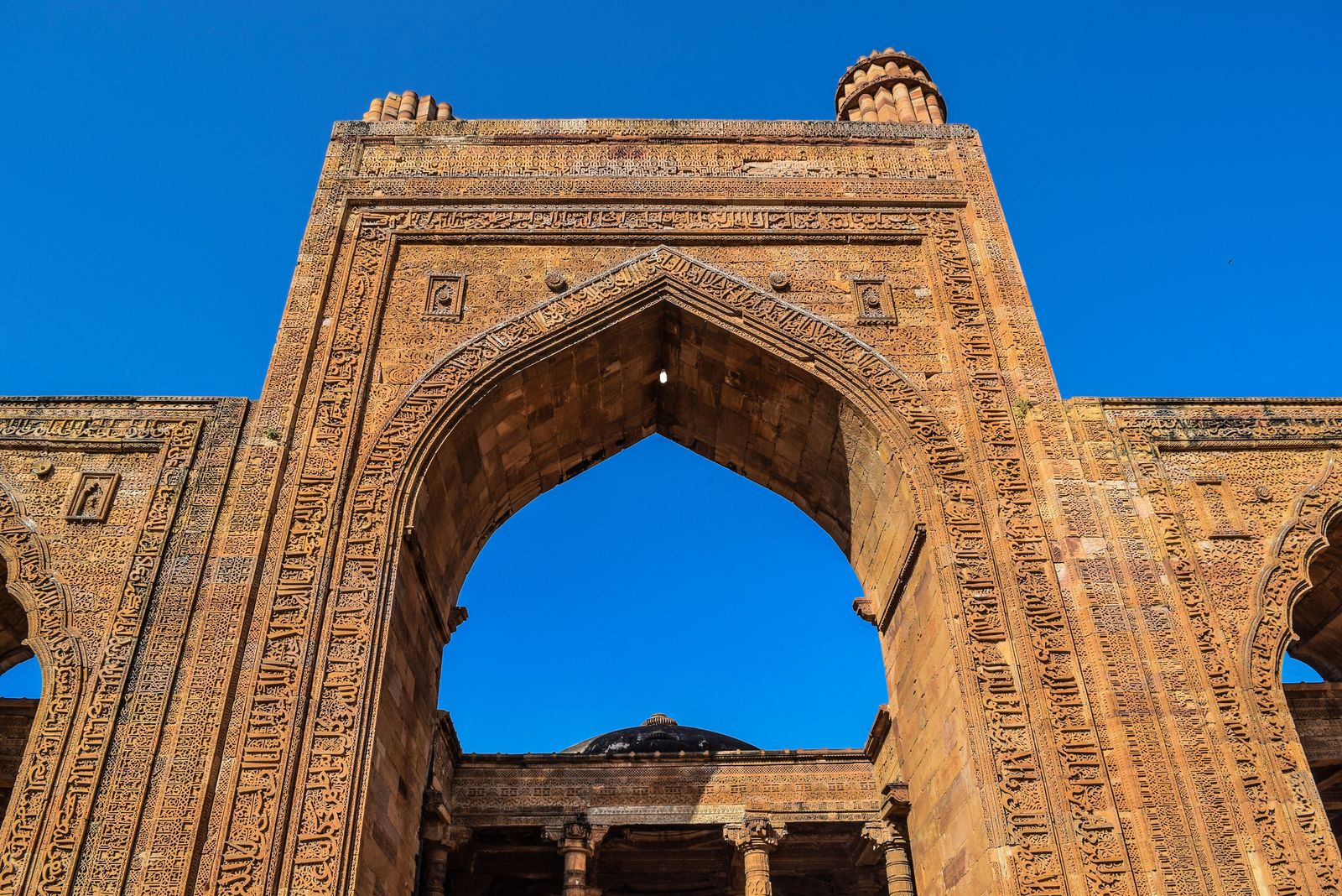Bands of carved Arabic calligraphy and geometric patterns on the arches of Adhai Din ka Jhonpra