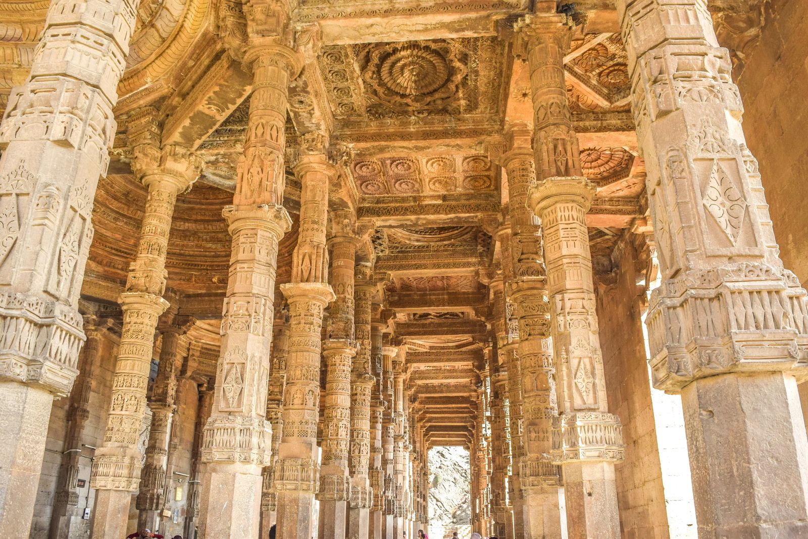 Rows of carved stone pillars stacked into tall columns inside Adhai Din ka Jhonpra in Ajmer