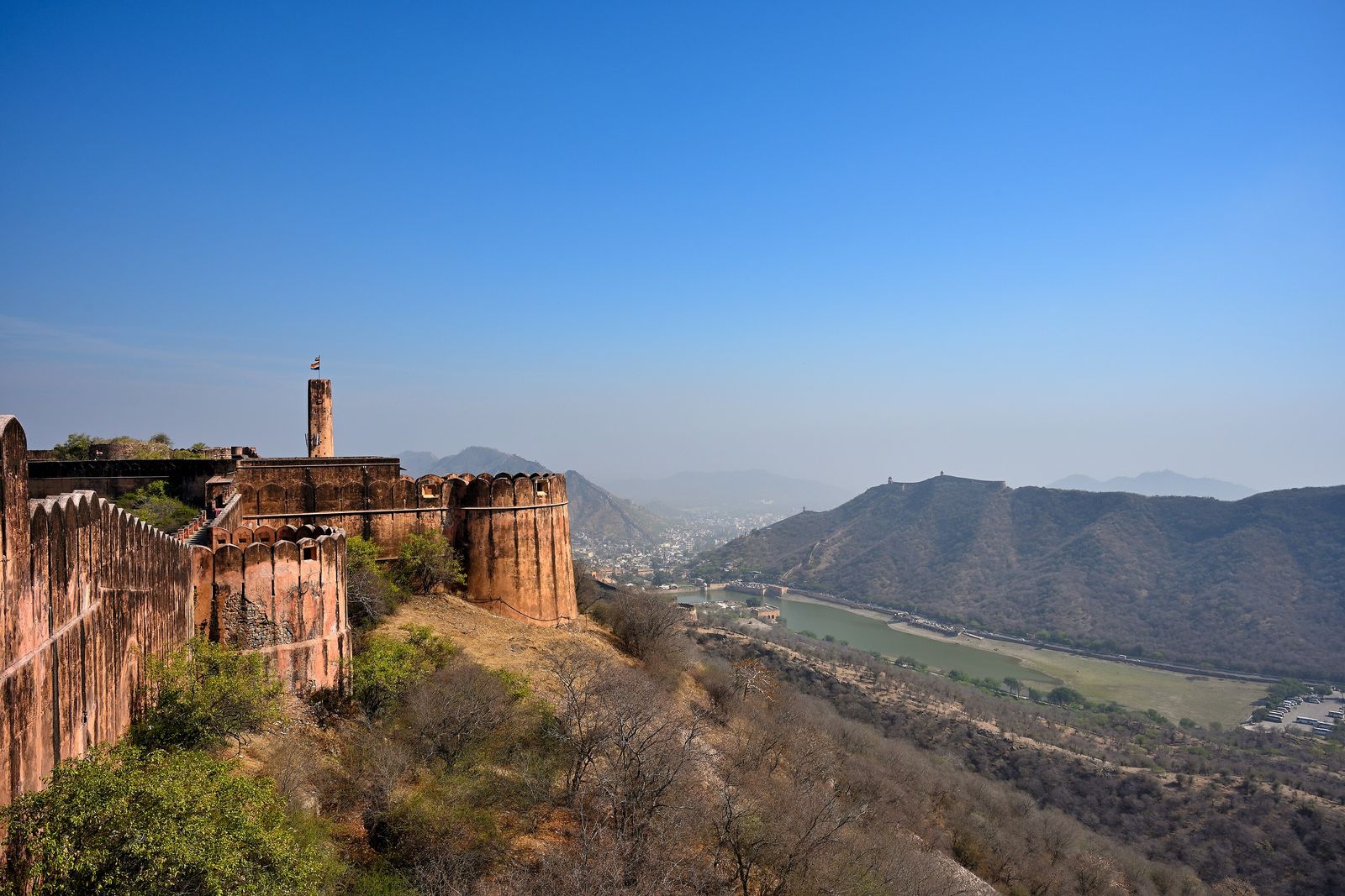 Amber Fort's ramparts and palaces rising above Maota Lake in the Aravalli hills at Amer