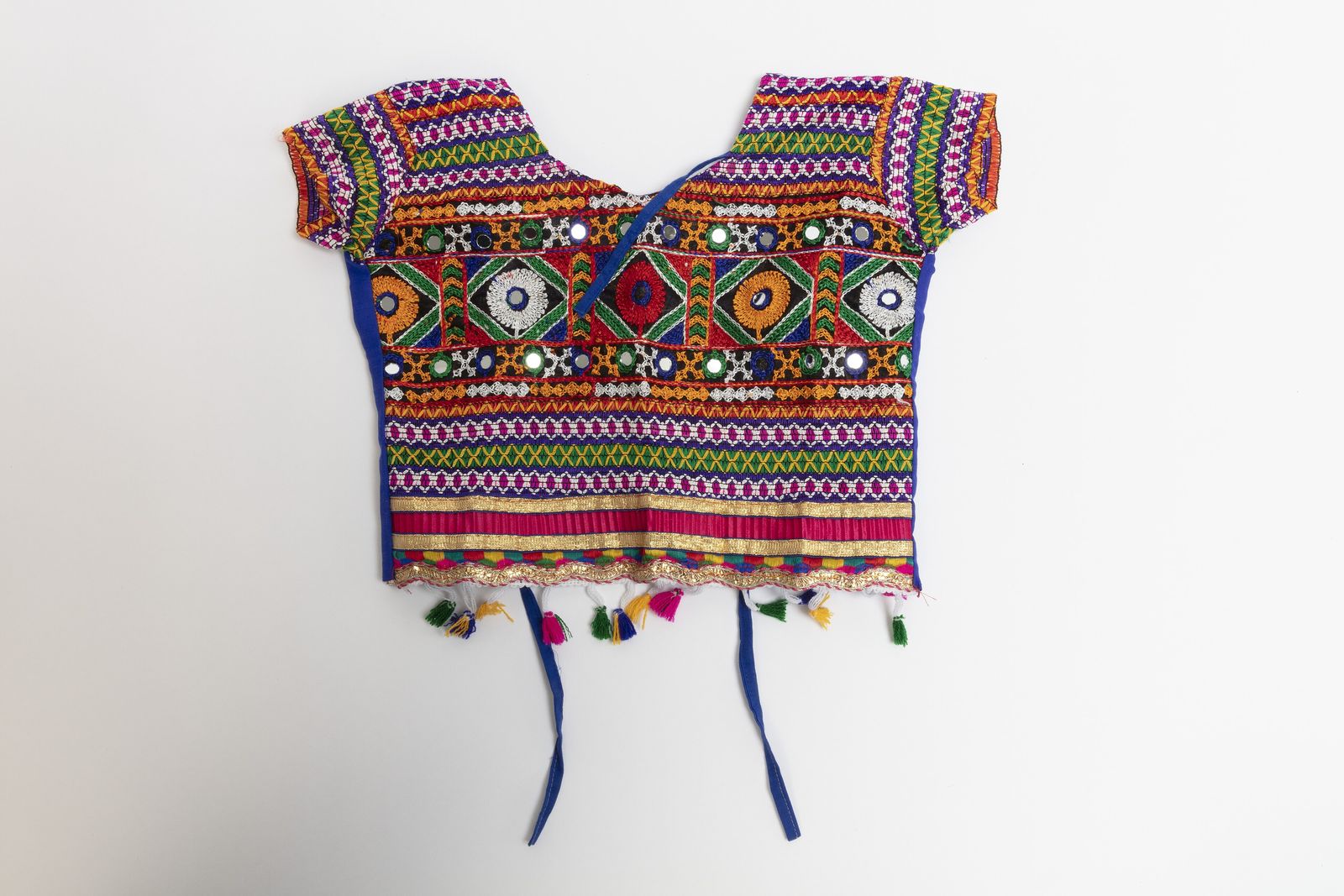 A girl's choli and skirt decorated with mirror embroidery, a style found in Rajasthan