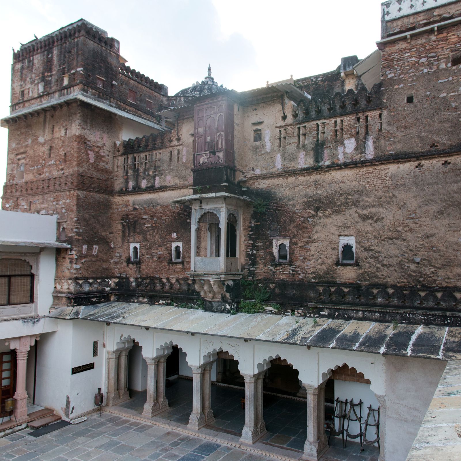 The garden courtyard and arched verandas of Castle Bijaipur in the village of Bijaipur, Mewar