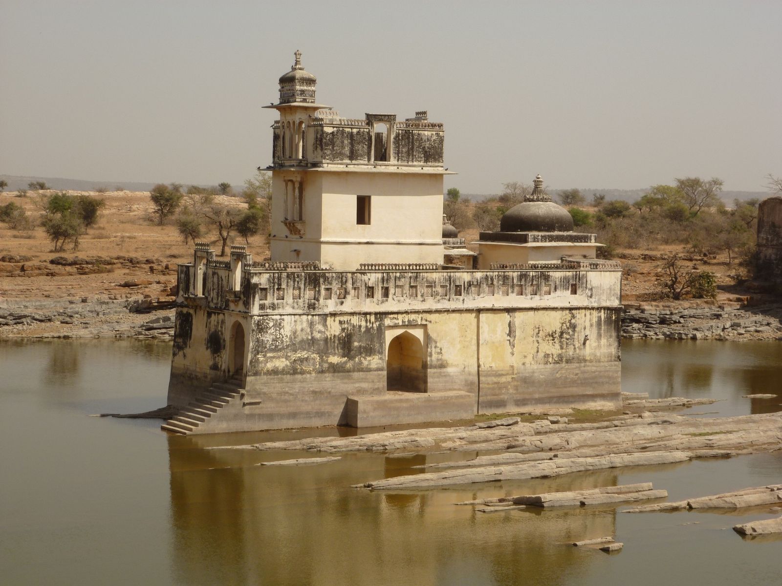 Padmini's palace, a pale pavilion reflected in the still water of a tank at Chittorgarh Fort