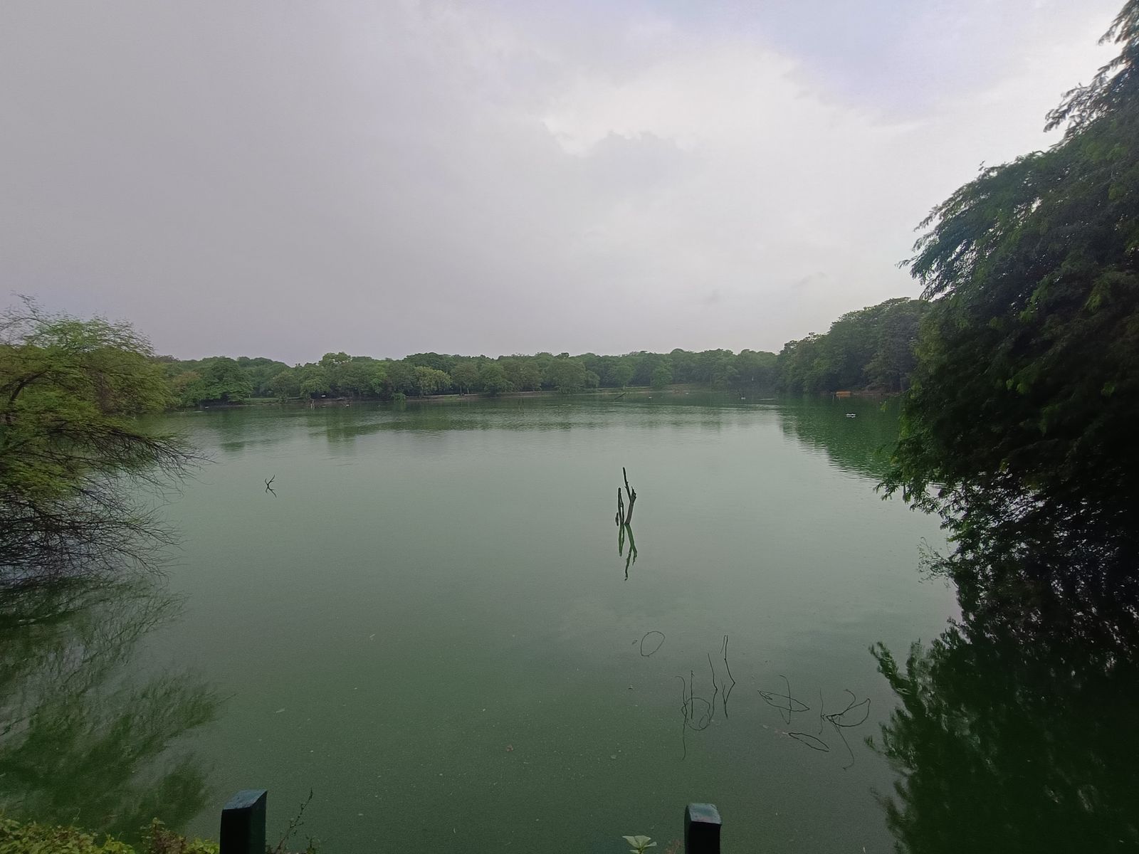 The medieval reservoir of Hauz Khas with the domed ruins of the fourteenth-century madrasa along its shore in Delhi