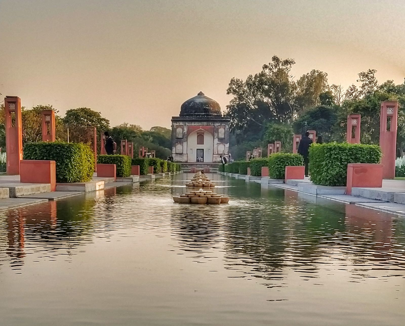 Lawns, a lotus pool and a domed sixteenth-century tomb in Sunder Nursery, the heritage park beside Humayun's Tomb in Delhi