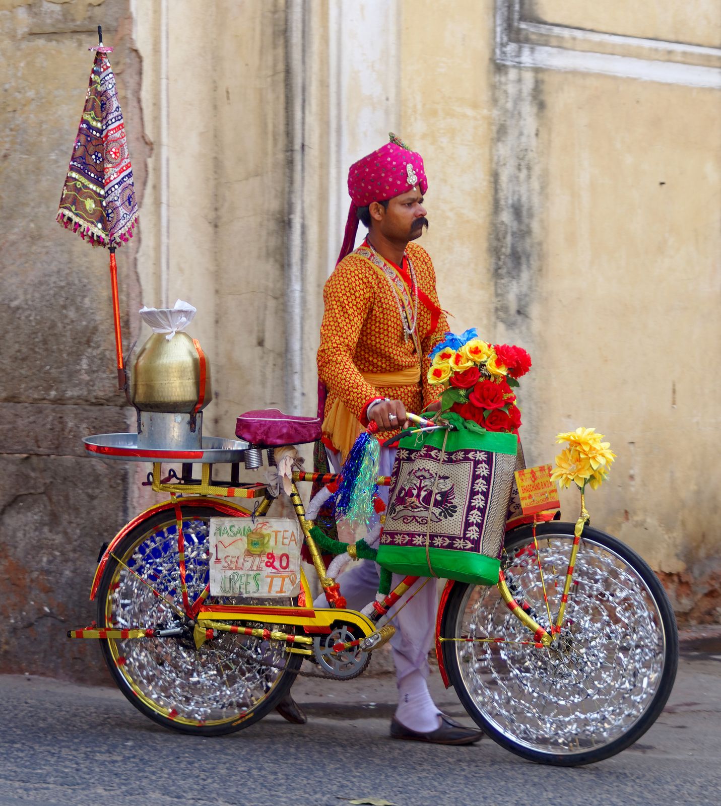 A man in a turban with a decorated bicycle in the streets of old Jaipur