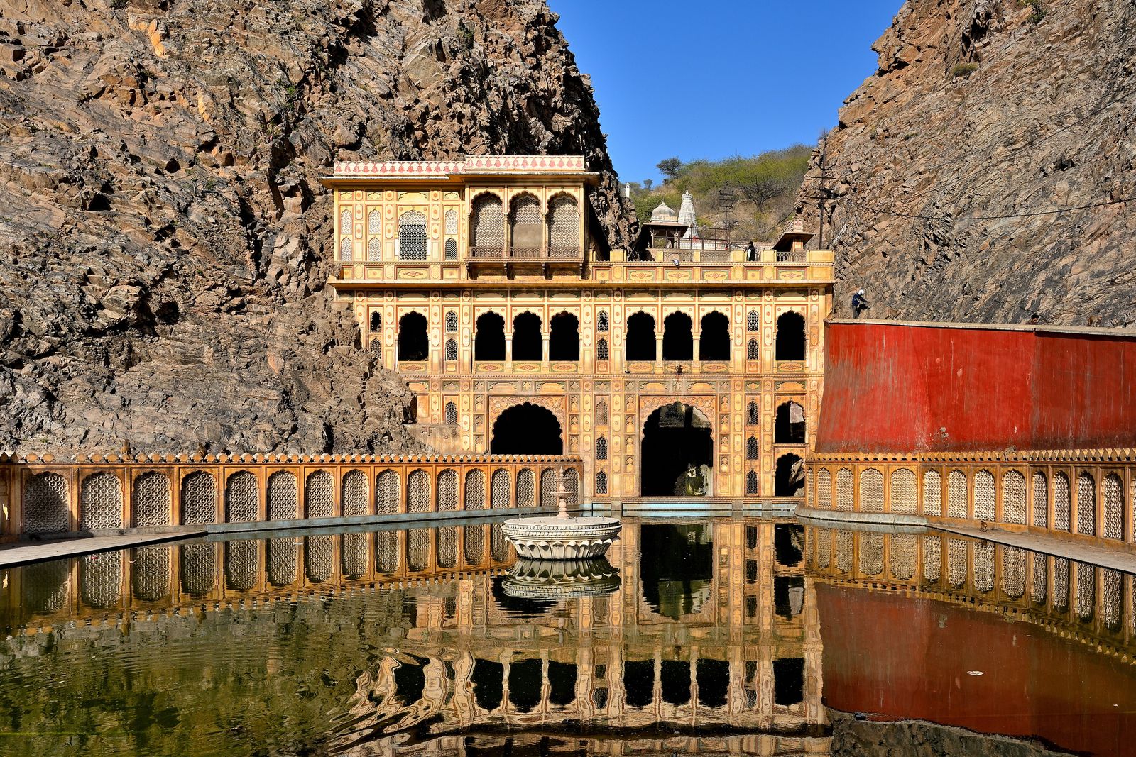 The pink sandstone temples and pavilions of Galtaji set in a narrow rocky gorge in the Aravalli hills east of Jaipur