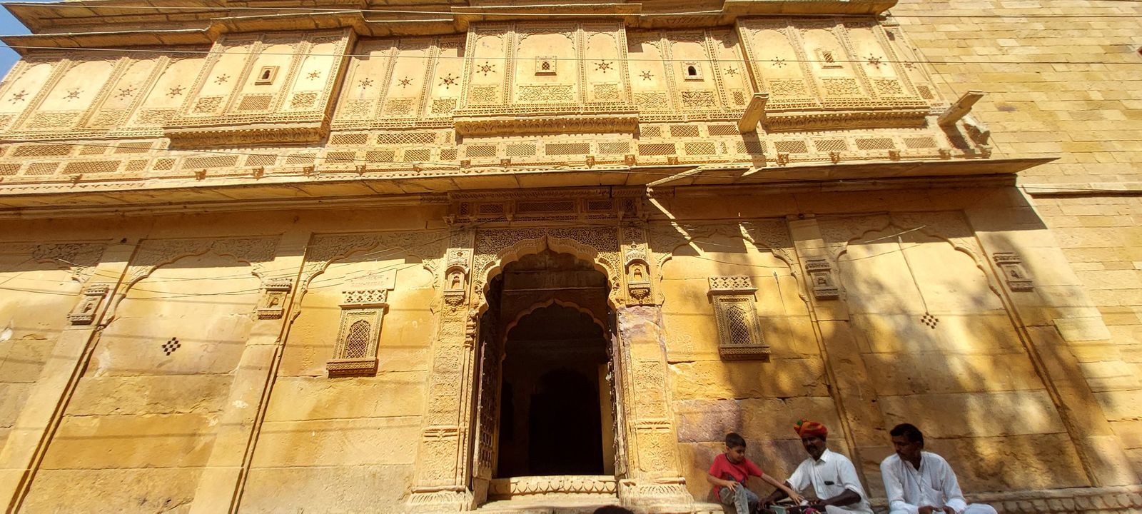 A narrow lane of carved yellow sandstone houses inside Jaisalmer Fort