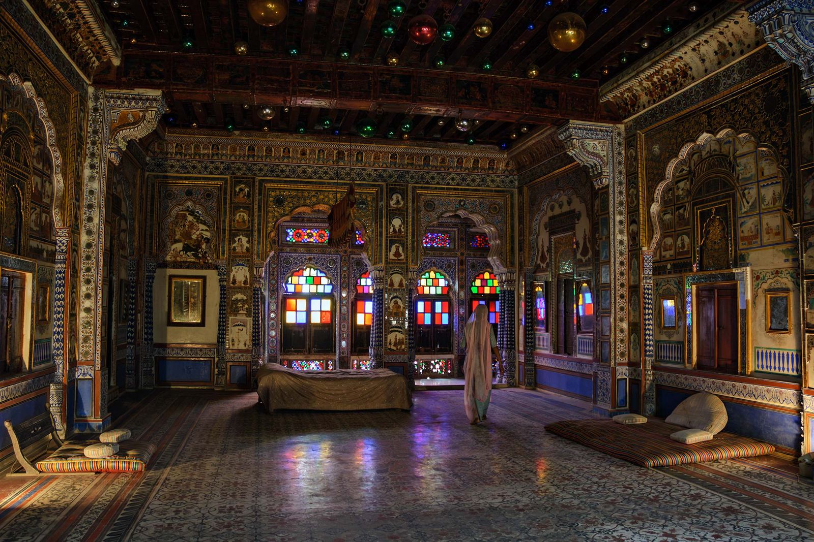The gilded ceiling, painted walls and stained glass windows of Phool Mahal inside Mehrangarh Fort