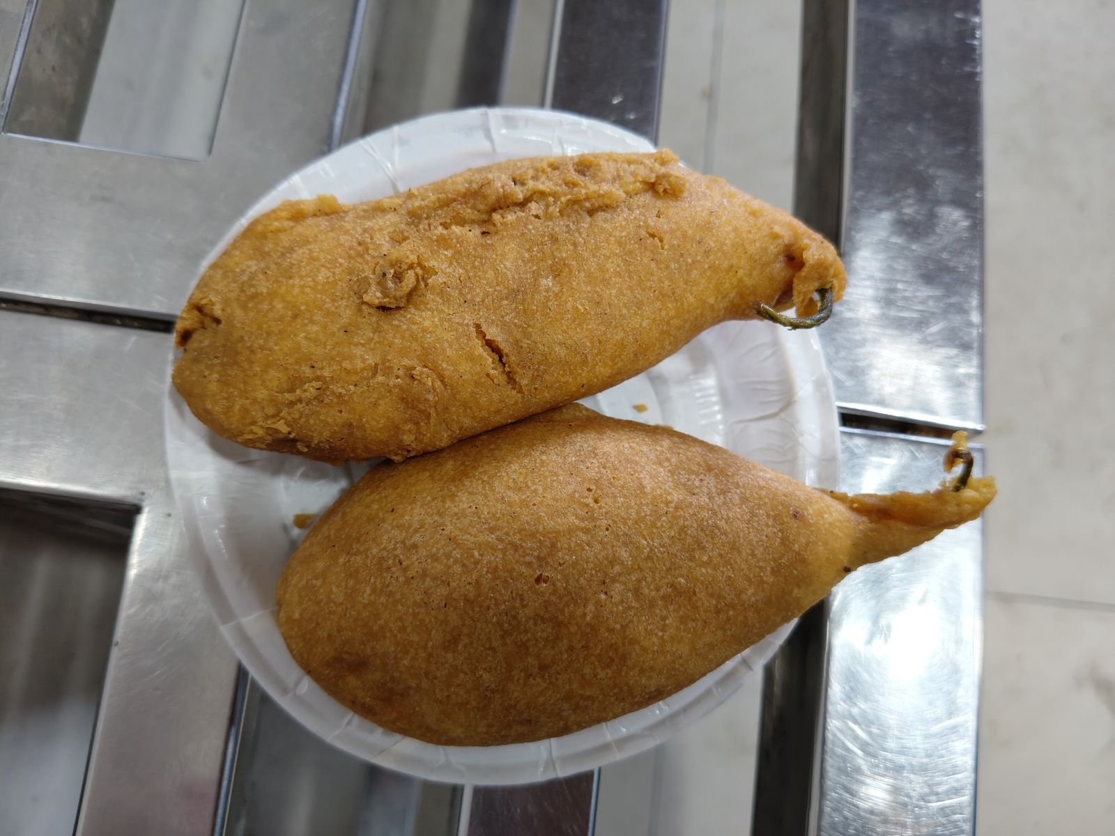 Golden fried mirchi bada, chillies stuffed with spiced potato, piled on a tray in Jodhpur