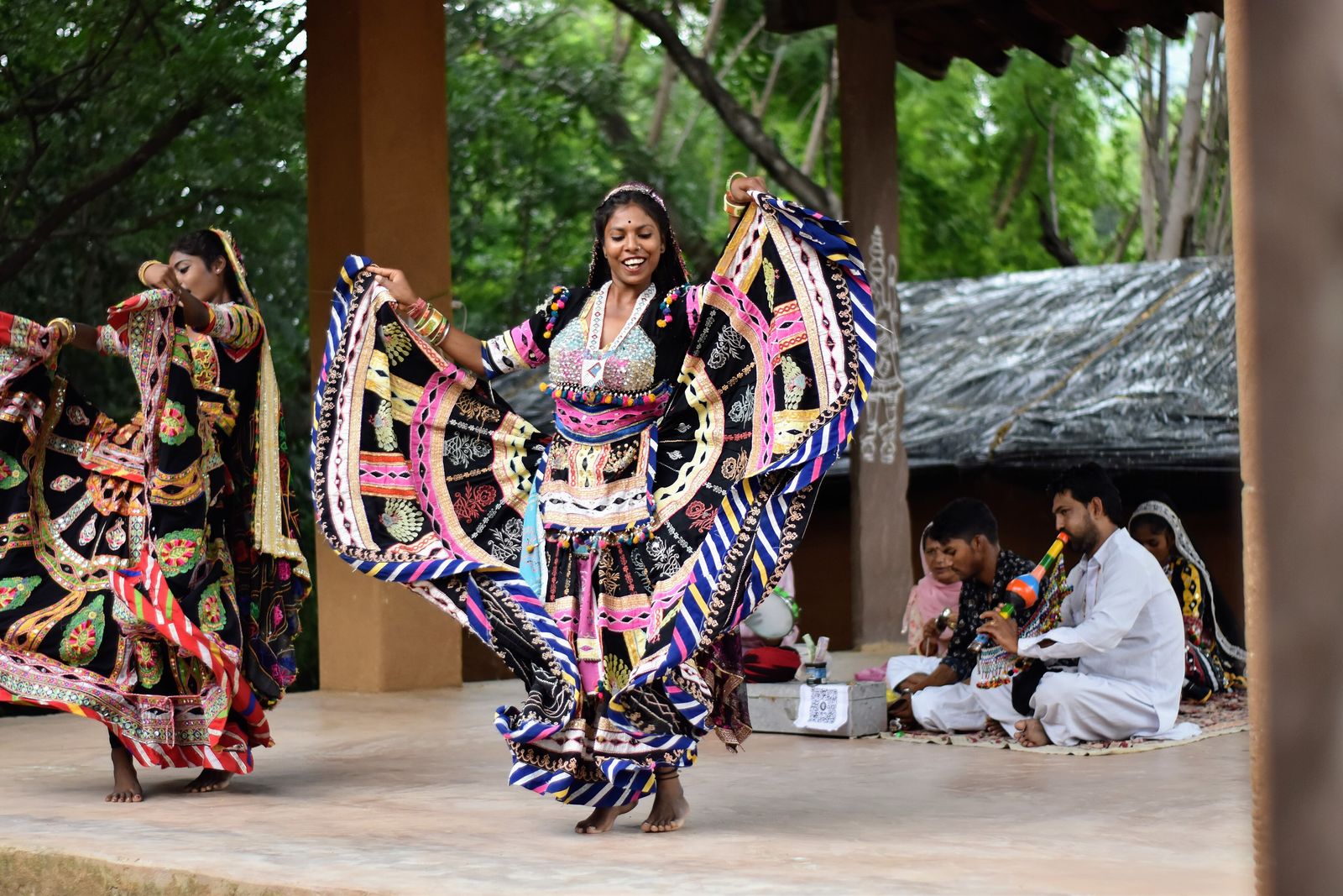 Kalbelia dancers in swirling black and silver skirts