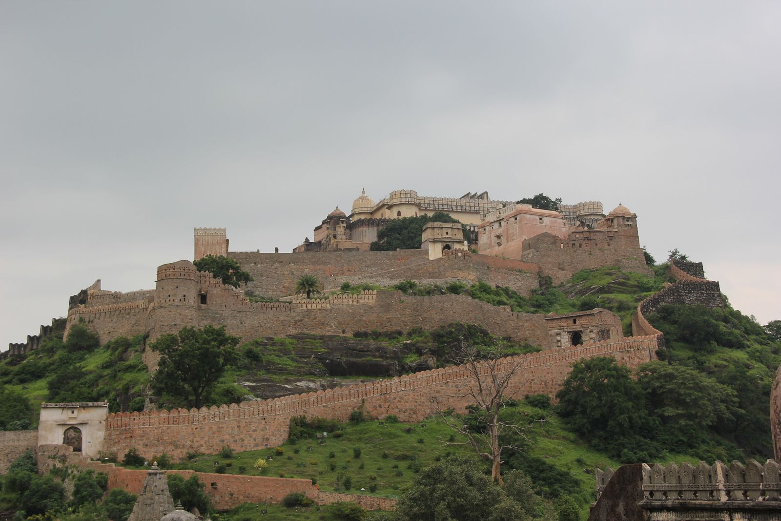 Green monsoon hills and rain clouds around the walls of Kumbhalgarh Fort in the Aravallis