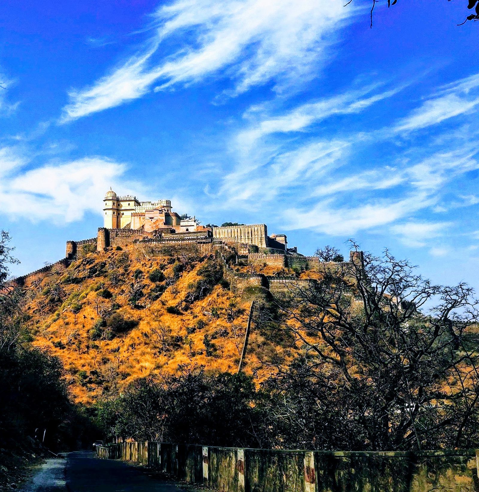 The great wall of Kumbhalgarh catching the first light of sunrise over the Aravalli hills