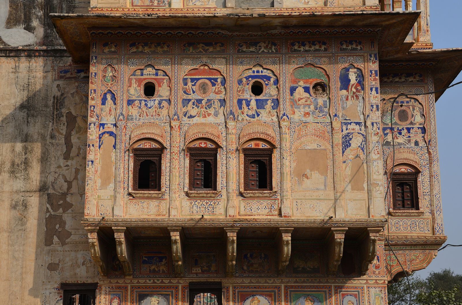 The painted outer walls and carved gateway of a merchant haveli in Mandawa, Shekhawati