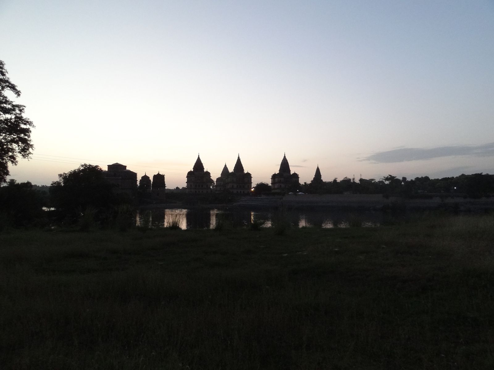 The tall spired chhatris of the Bundela kings on the bank of the Betwa at Orchha at sunset