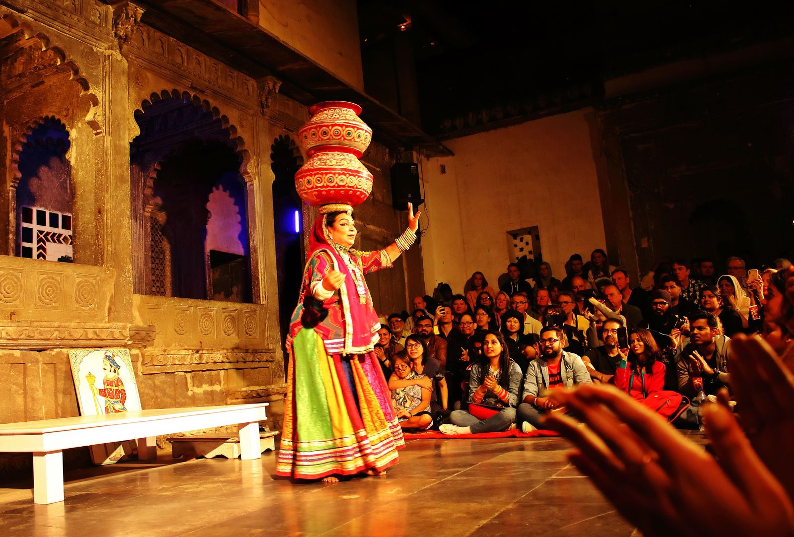 A Bhavai dancer balancing pots on her head before an audience