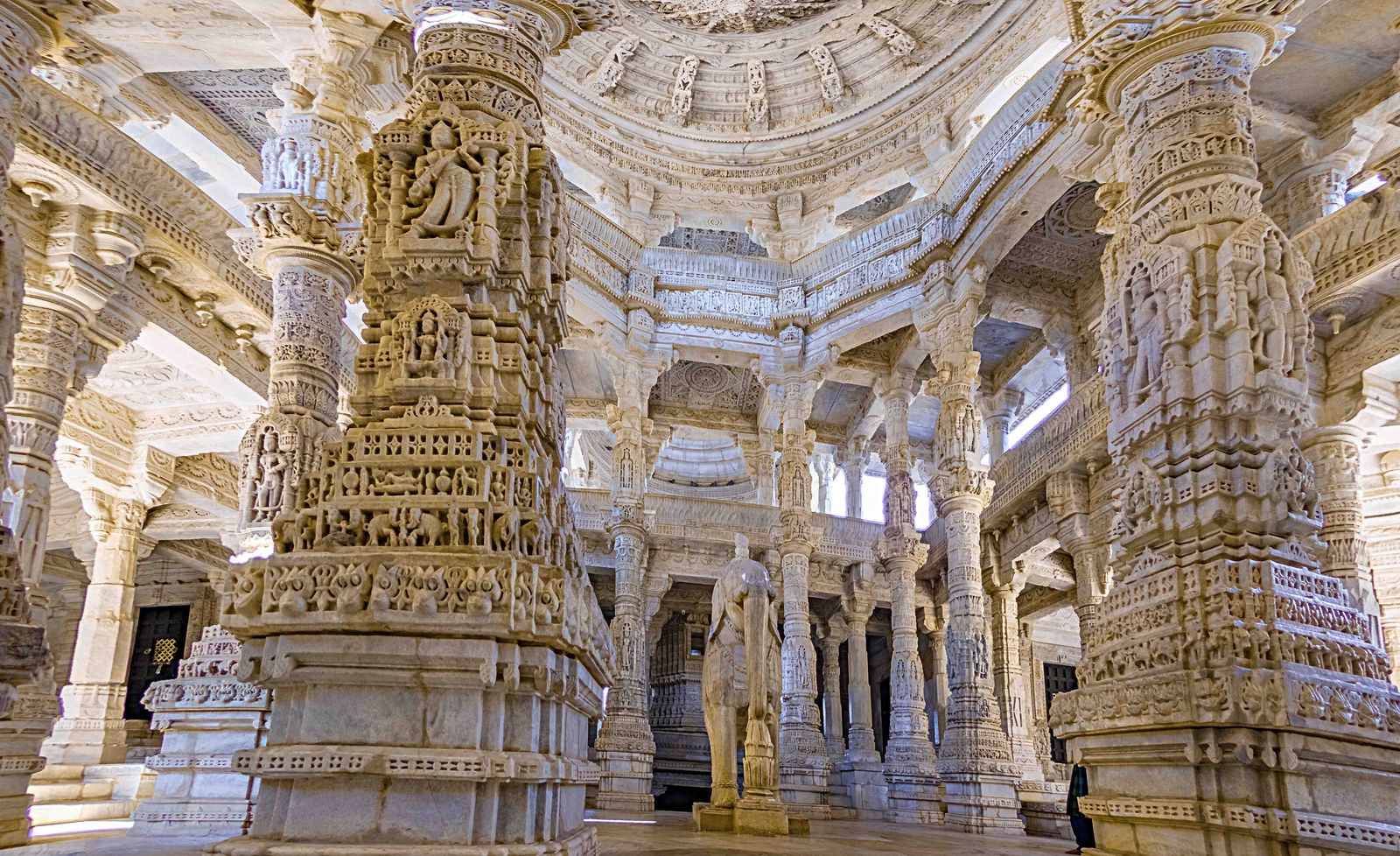 Rows of carved white marble pillars and arches inside the Jain temple at Ranakpur