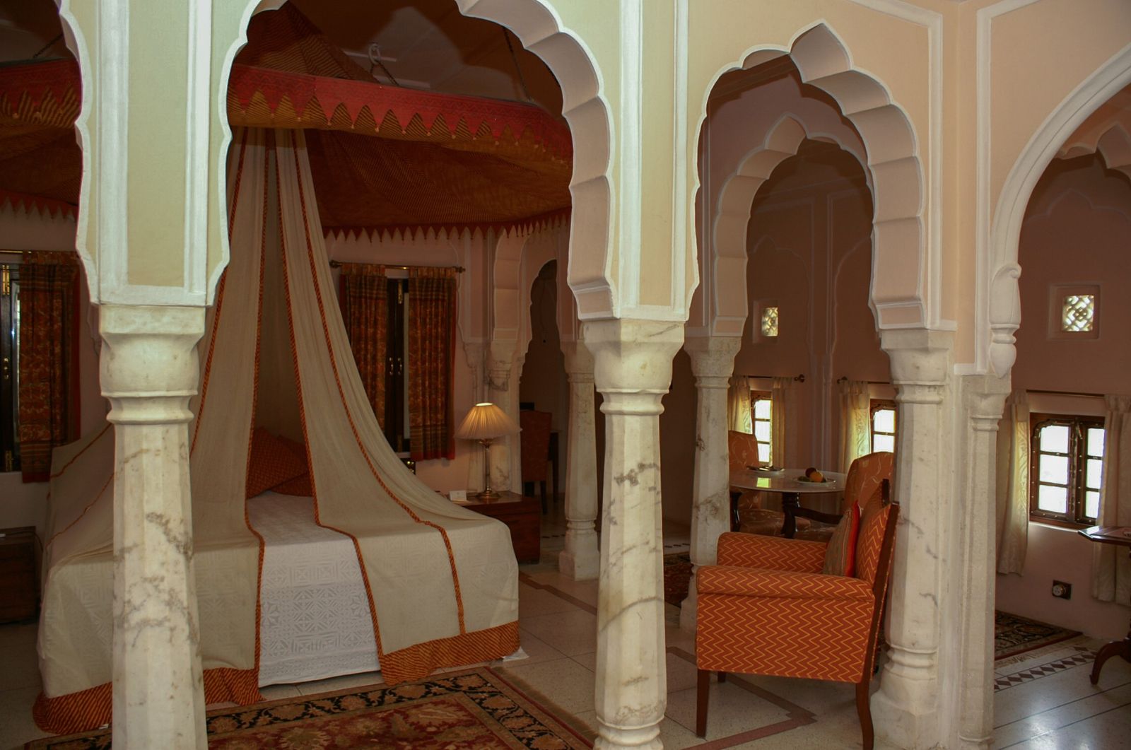 A canopy bed in a guest suite at Samode Palace