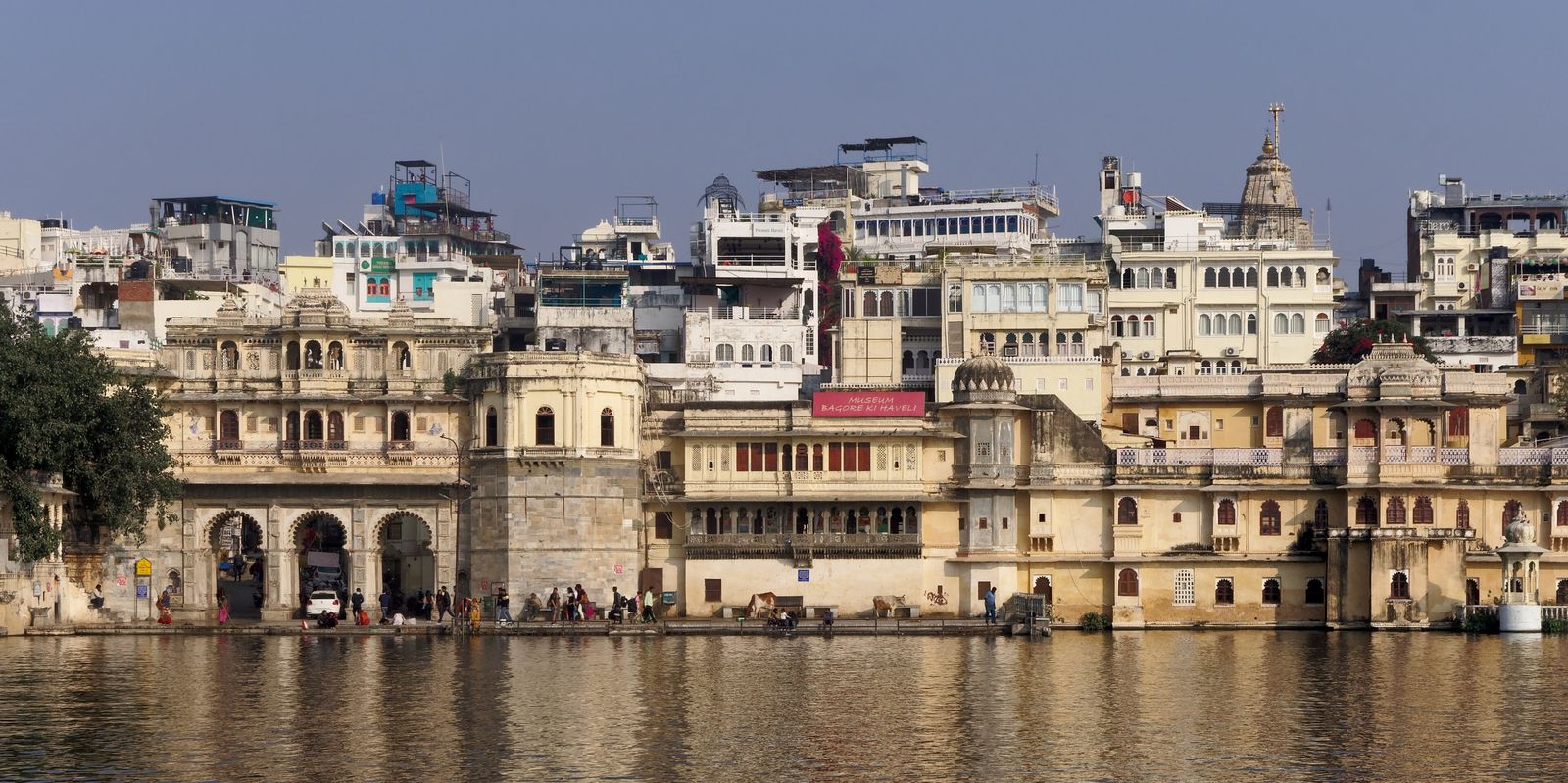 Steps of Gangaur Ghat leading down to Lake Pichola beneath a triple-arched gateway in Udaipur