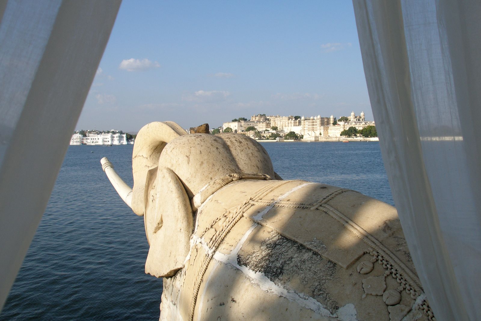 The carved stone elephants at the water's edge of Jag Mandir island palace on Lake Pichola, Udaipur