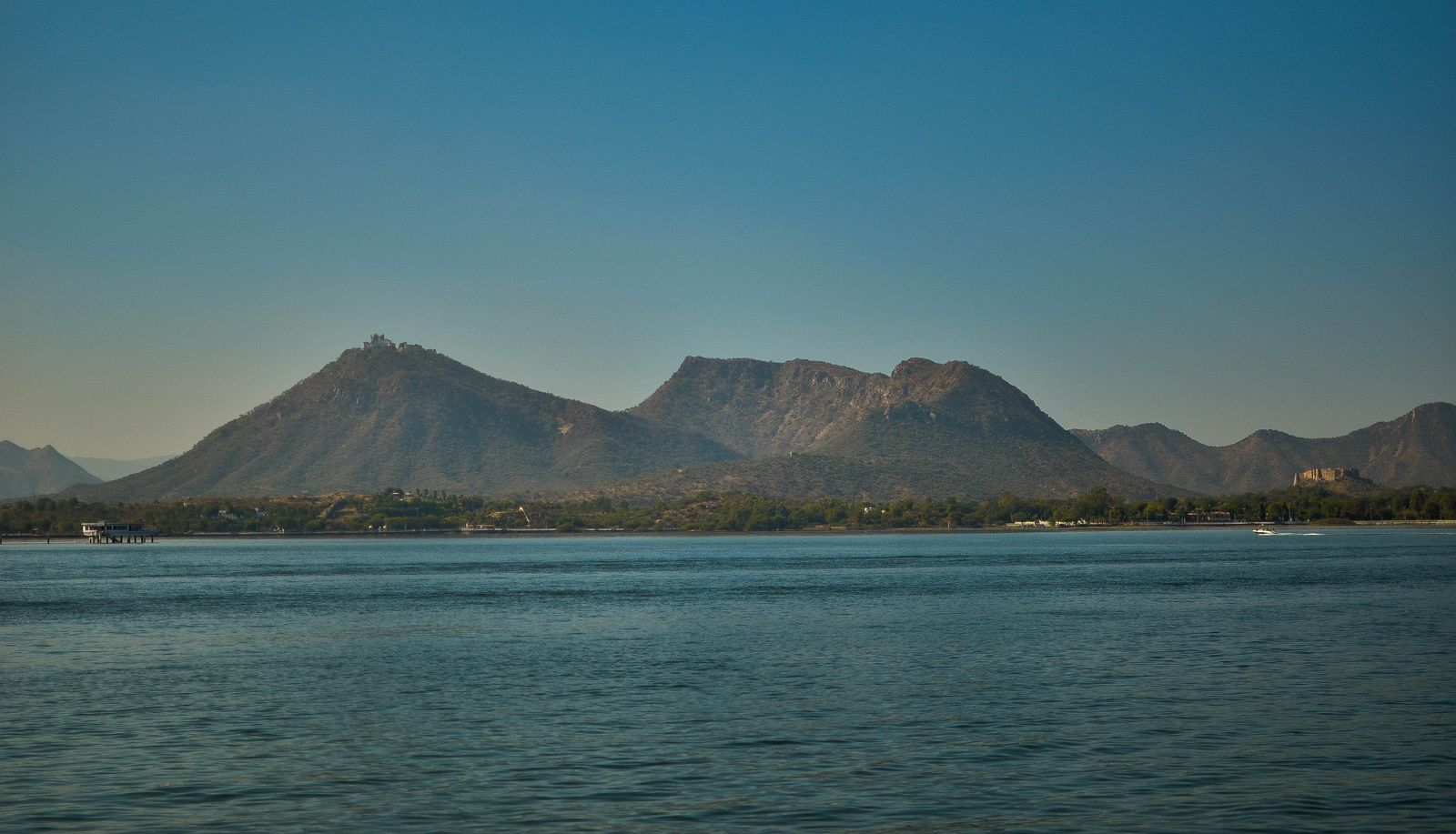 Fateh Sagar Lake with the Sajjangarh Monsoon Palace on its forested hill above Udaipur